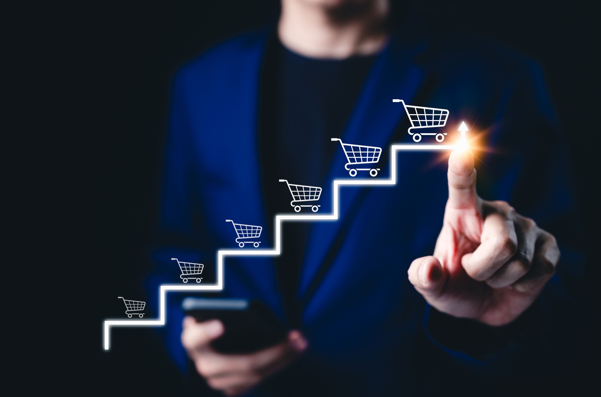 E-commerce growth and online sales strategy development. Businessman pointing to arrow with shopping cart icons, online sales growth, digital marketing success, performance optimization for business,
